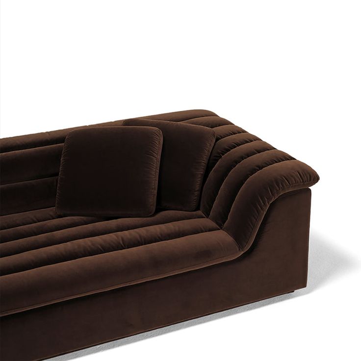 a brown couch sitting on top of a white floor