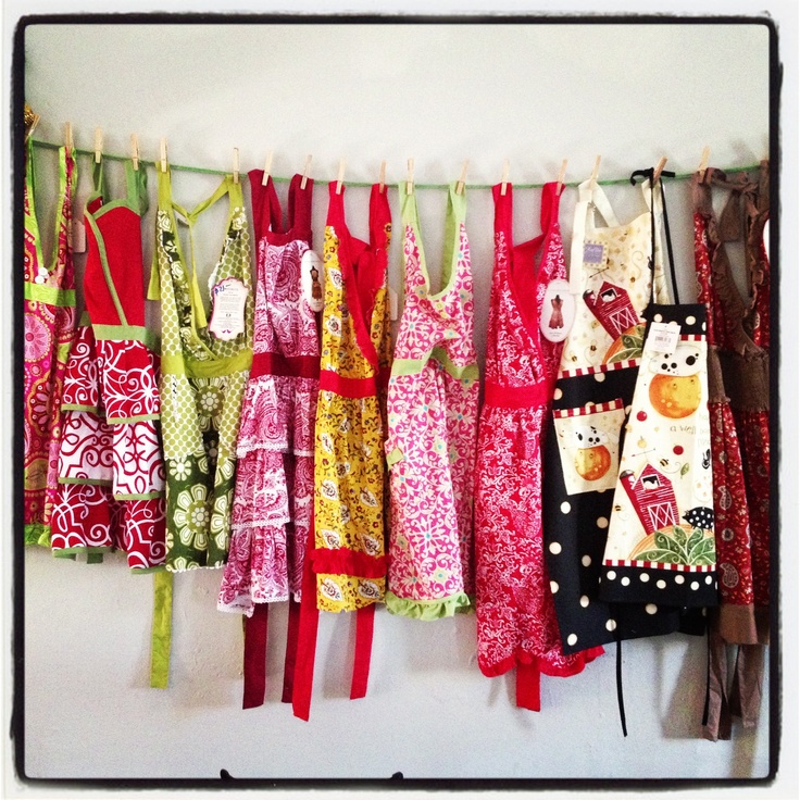 colorful aprons hanging on a line in a kitchen or barbeque room, ready to be used for cooking