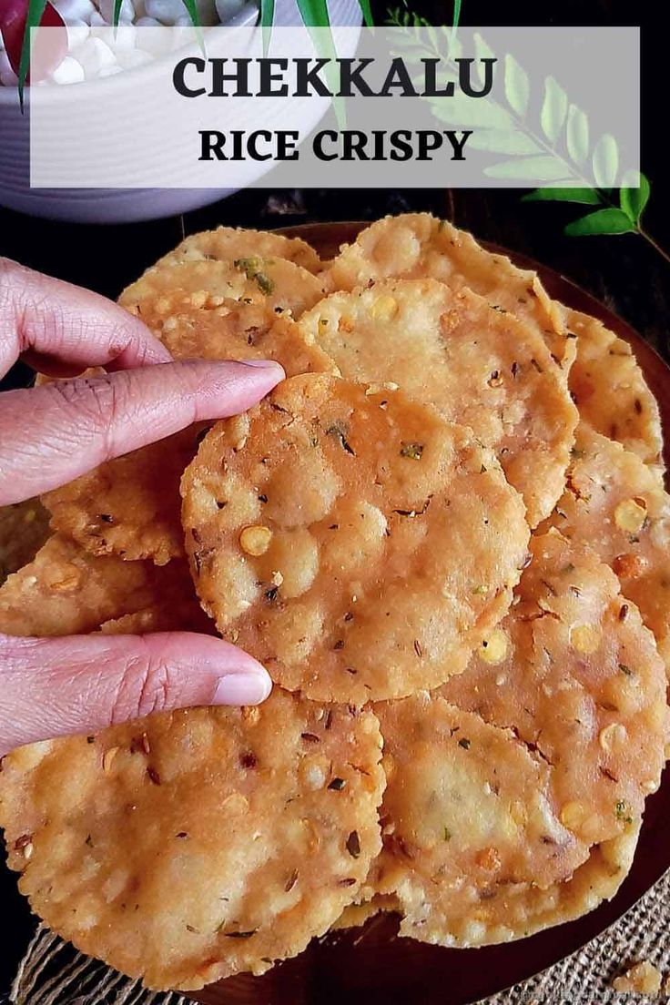 a person holding their hand over some food on a plate with the words chekkalu rice crispy