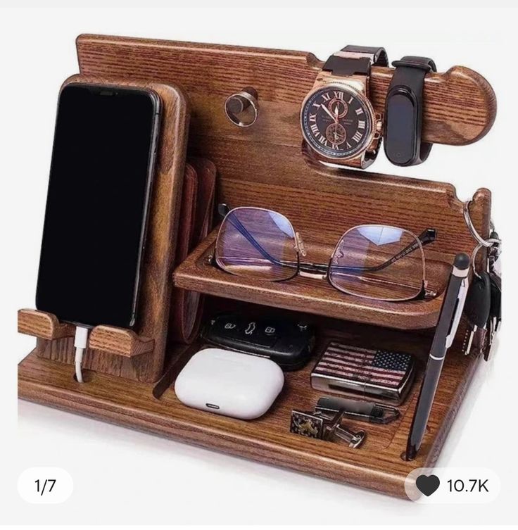 a wooden desk with glasses, cell phone and other items on it's shelf