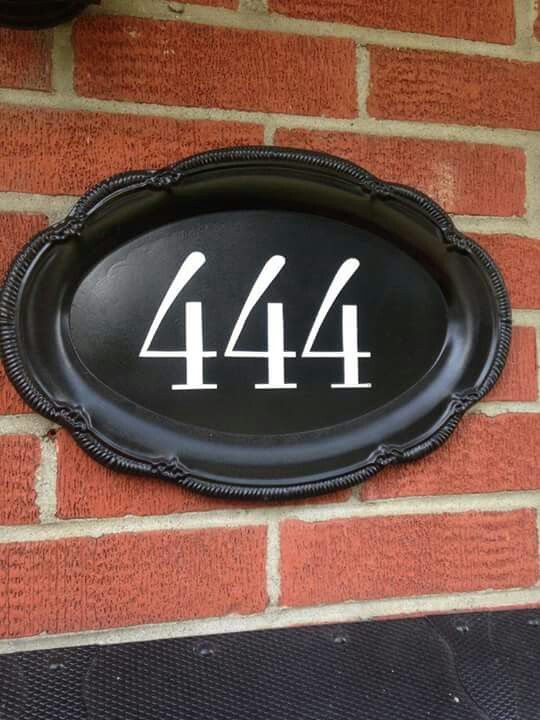 a black and white sign that says 414 on the side of a brick wall