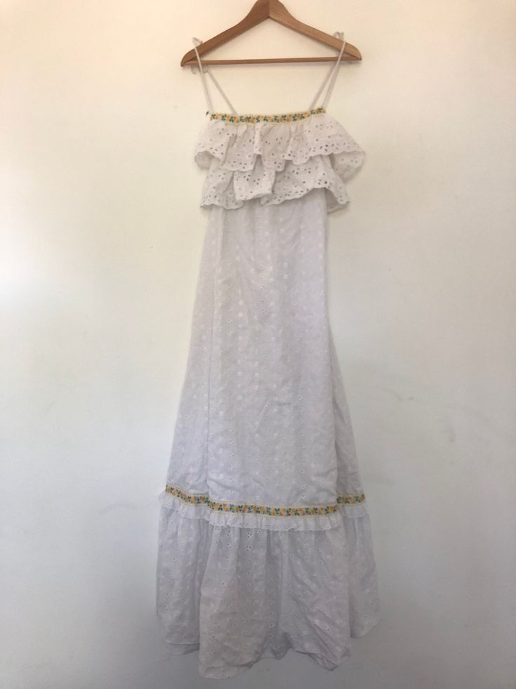 White Cotton Dress | Maxi Summer Dress | Long Prairie Boho Dress | Vintage Dress | Lace Festival Peasant Bohemian | Ruffled Sleeveless Gown | see through dress | white beach dress |  broderie eyelet lace pattern | Tags Description: A brilliant prairie dress from the late 1970s (perhaps early 1980s).  This vintage piece is white and made of cotton.  It is also not see through and has a white inner lining. It features a brilliant broderie eyelet lace pattern throughout and has ruffle detail on the Bohemian Maxi Dress With Ruffle Hem And Straps, Sleeveless Ruffled Maxi Dress For Festivals, Bohemian Maxi Dress With Ruffled Straps, Bohemian Sundress With Ruffled Straps For The Beach, Bohemian Sleeveless Sundress With Ruffle Hem, Bohemian Sundress With Ruffled Straps, Sleeveless Bohemian Maxi Dress With Ruffles, Bohemian Sundress With Ruffle Hem And Straps, Bohemian Sundress With Ruffle Hem And Ruffled Straps