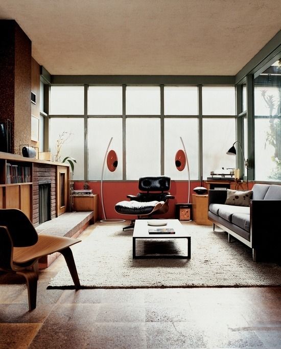 a living room filled with furniture and large windows