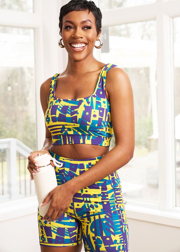 Style #: A2017NTSThe Adamma African Print Sports Bra makes for a stylish take on traditional activewear. The bold printed style can be worn to the gym with our Kimba biker shorts or with a pair of jeans for a night out with friends. Shop all our activewear here. Squared neckline Elastic band with D'IYANU logo on back Medium support Wicking properties 87% nylon/13% spandex​ Designed in the USA, Imported Cold wash. Tumble dry low. Model size: Small | Height 5'11" | Bust 34" | Waist 27" | Hips 38" Trendy Stretch Activewear For Sports, Fitted Graphic Print Activewear For Training, Fitted Graphic Print Activewear For Sports, Sporty Multicolor Athletic Shorts With Built-in Shorts, Yellow Sports Biker Shorts With Built-in Shorts, Multicolor Graphic Print Activewear For Sports, Multicolor Compression Activewear For Sports, Green Athleisure Activewear For Streetwear, Summer Compression Sportswear