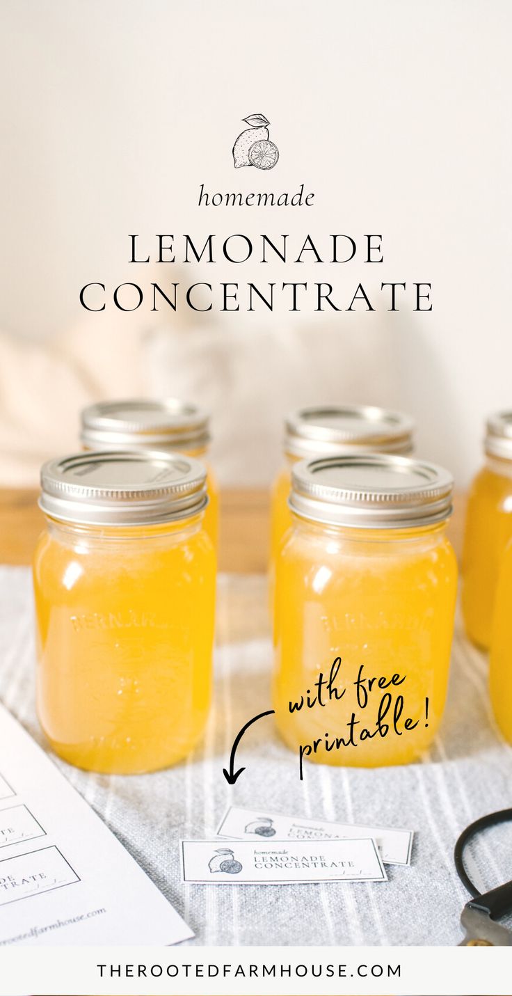 four jars filled with lemonade sitting on top of a table next to a pair of scissors