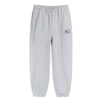 The Nike x Stussy Crossover SS22 Solid Color Logo Alphabet Embroidered Athleisure Casual Sports Pants Us Edition Unisex Gray is a must-have for any athleisure wardrobe. This unisex piece features an embroidered alphabet logo for a unique look, and the solid gray colorway is perfect for any occasion. The lightweight fabric is designed to keep you comfortable during any activity, and the adjustable drawstring waistband ensures a perfect fit. Inspired by the classic Nike x Stussy collaboration, this piece is perfect for any fan of the series. Get ready for any activity with the Nike x Stussy Crossover SS22 Solid Color Logo Alphabet Embroidered Athleisure Casual Sports Pants Us Edition Unisex Gray. (Casual/Unisex/Crossover/Embroidery/Solid Color/U.S. Edition/Gift to Boyfriend) Nike Cotton Sweats, Nike Relaxed Fit Sweats With Elastic Waistband, Nike Relaxed Fit Bottoms With Ribbed Waistband, Nike Relaxed Fit Pants With Ribbed Waistband, Cotton Sportswear Bottoms With Logo Detail, Nike Relaxed Fit Bottoms With Ribbed Cuffs, Nike Sweats With Pockets In Relaxed Fit, Nike X Stussy Joggers, Nike Streetwear Pants With Comfort Waistband