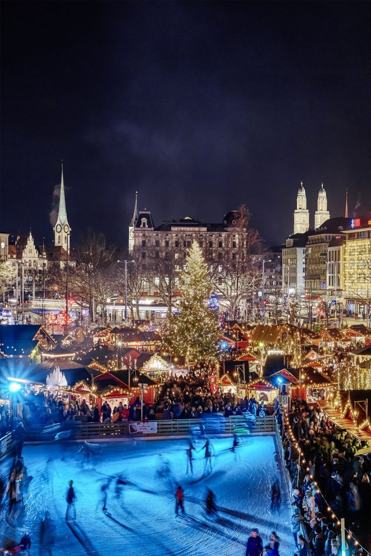 an outdoor christmas market is lit up at night