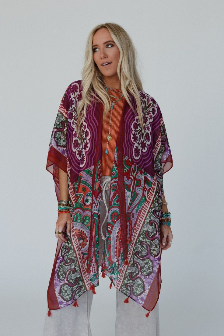 You'll add a stunning addition to your boho wardrobe with our Tabitha Floral Kimono, sure to become a cherished piece in your collection, adding a touch of bohemian glamour to every occasion! You'll love layering with this eye-catching kimono becasue it features: Lightweight, woven, slightly sheer fabric with a so pretty print throughout Relaxed and loose kimono silhouette Classic open front closure Loose kimono style sleeves and side slits created by single side seams So cute tassel details alo Bohemian Printed Kimono For Beach Cover-up, Bohemian Kimono With Boho Print For Beach Cover-up, Multicolor Fall Festival Kimono, Fall Festival Multicolor Kimono, Bohemian Long Kimono With Vibrant Print, Long Bohemian Kimono With Vibrant Print, Bohemian Brown Kimono For Fall, Multicolor Bohemian Printed Kimono, Bohemian Multicolor Printed Kimono