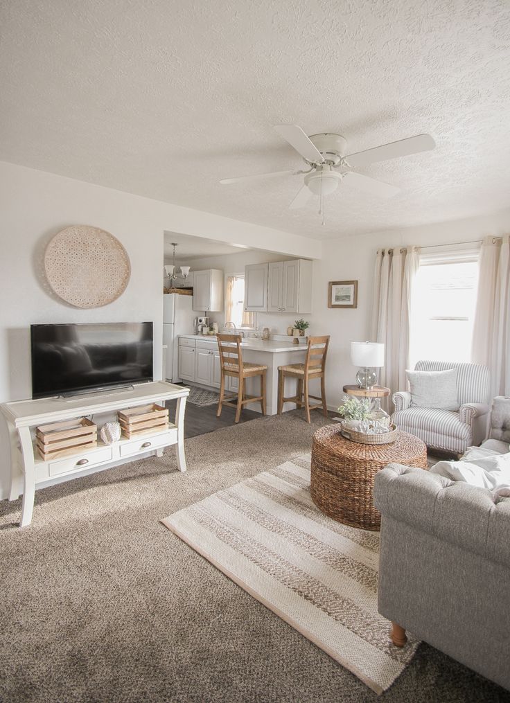 a living room filled with furniture and a flat screen tv