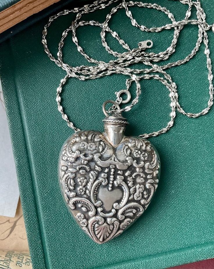 Juliet necklace is a gorgeous necklace that can be worn on its own or layered with your other favorite pieces. Antique marked sterling silver heart pendant hangs on two silver-plated NOS chains that measure 18 inches individually, equaling 36 inches in total. Heart is beautifully decorated with stamped designs and petite flowers. Heart pendant measures 2 1/8 inches by 1 7/8 inches. ~ An enchantingly unique design from Jewelry by Chyrise Elegant Long Engraved Necklace, Elegant Hallmarked Pendant Locket Necklace, Elegant Medallion Necklace With Heart Charm, Silver Sterling Silver Heart Pendant Locket Necklace, Elegant Heart Pendant Jewelry With Sterling Silver Clasp, Elegant Sterling Silver Hallmarked Heart Necklace, Luxury Sterling Silver Heart Pendant Necklace, Luxury Silver Heart Necklace With Heart Charm, Silver Double Heart Engraved Necklaces