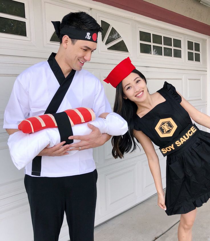 a man and woman dressed up as sushi and ken in front of a garage door