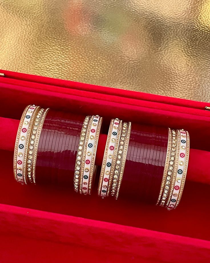 three bangles sitting on top of a red box