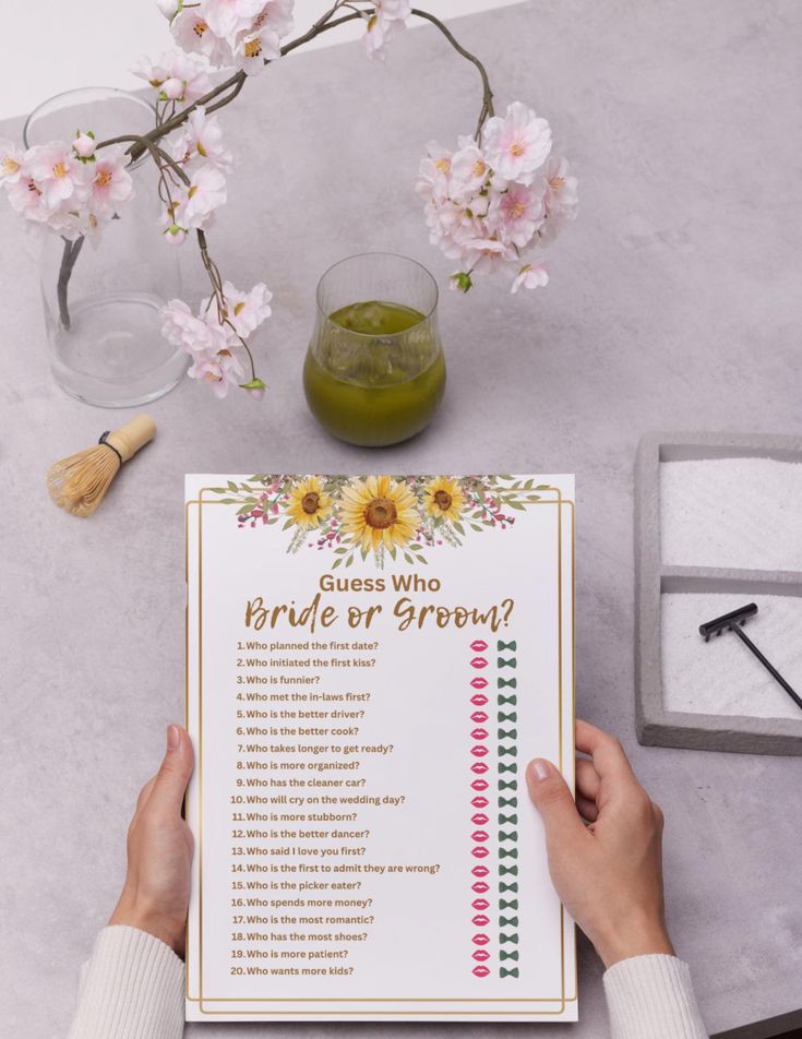 a person is holding up a flower themed bridal checklist with flowers in the background