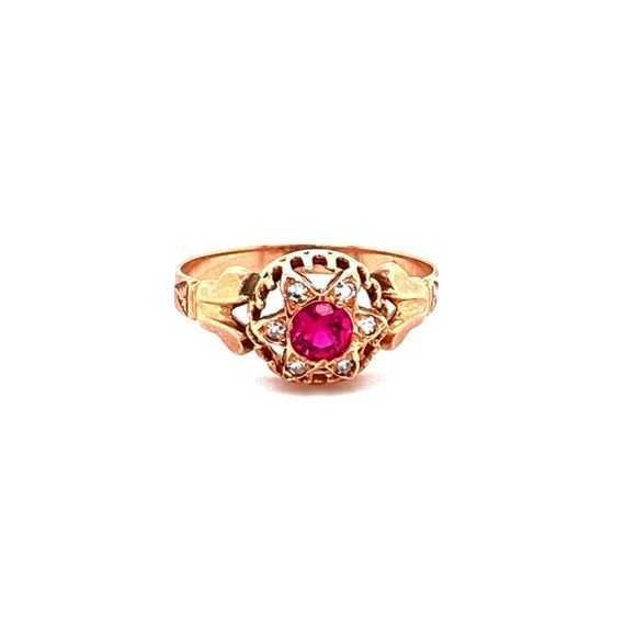 Such an eyecatch! This Victorian era ring is made in lush 18K gold and set with a synthetic red ruby in the center that shimmers in the light. Surrounding that mesmerizing stone is a halo of white diamonds that are pave set and total to .05ctTW. The head of the ring measures 9.41mm long, 9.71mm wide and sits 5.11mm tall. The ring is a size 7 and weighs 1.3DWT.  C9168BYVPM  --Please reference our policy for more details--***For International orders, please provide a phone number for shipping purp Heirloom Red Gold Signet Ring, Antique Red 14k Gold Signet Ring, Antique Red Signet Ring In 14k Gold, Heirloom Yellow Gold Ruby Signet Ring, Heirloom Ruby Signet Ring In Yellow Gold, Antique Yellow Gold Ruby Ring, Antique Red Ruby Ring In 14k Gold, Antique Ruby Ring In Yellow Gold, Heirloom Ruby Signet Ring With Hallmark