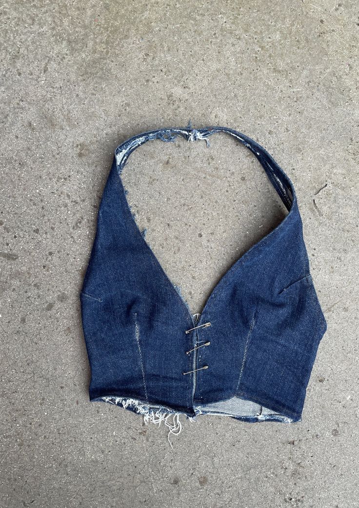 Denim, we love it. The Phobya Halter, in original indigo denim! - just in time for summer. Hand crafted from top-quality sustainable denim and completely unique. Finished with the statement Safety Pin Closure and adjustable neck strap.  This top is designed to be uniquely worn, adjusting the pins to the wearer. - Safety Pin closure - Handmade  - One piece halter-neck and waistcoat design - Fitted waist - Cropped length - Pre-washed   - Sustainable dead-stock denim  - Available in black and blue Fitted Pre-washed Blue Jeans, Summer Washed Blue Rigid Denim Jeans, Washed Blue Rigid Denim Jeans For Summer, Fitted Distressed Jeans For Summer, Fitted Denim Blue Cotton Jacket, Summer Medium Wash Cotton Denim Jacket, Summer Cotton Denim Jacket In Medium Wash, Dark Wash Washed Cotton Denim Top, Summer Indigo Denim Vest