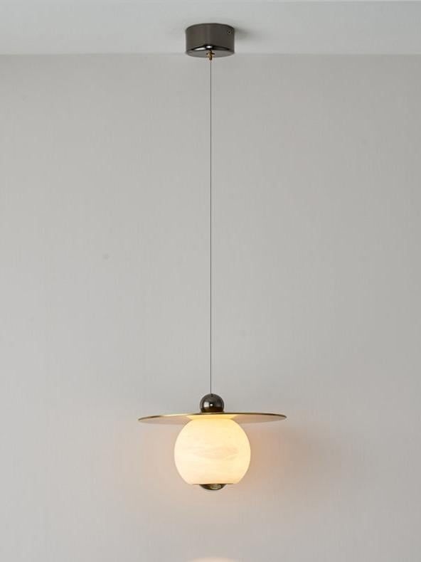 a light fixture hanging from the ceiling in a room with white walls and flooring