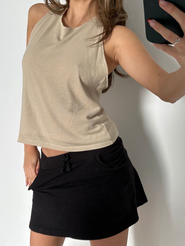 Your new favourite knit blouse of the season. The Pointsetta Top. The perfectly soft, nude color versatile piece. This elegant top is worn halter, with a low back and perfectly sculpted tie top that makes the ideal skinny scarf detailing when wanted to be worn that way. This top is made in the US from 100% recycled luxury knit. Chic Stretch Top With Tie Back, Versatile Backless Tie-back Top, Fitted Beige Halter Neck Tank Top, Beige Fitted Halter Neck Tank Top, Beige Stretch Crop Tank Top, Chic Stretch Tank Top With Tie Back, Chic Beige Tops With Tie Back, Beige Halter Neck Top For Day Out, Chic Beige Tie-back Top