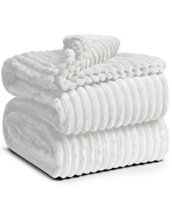 three white towels stacked on top of each other in front of a white background,