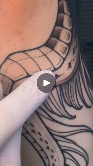 a person with a tattoo on their neck pointing at the camera man's finger