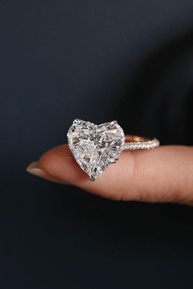 Specification *Diamond Material : Cubic Zirconia (CZ) / Moissanite (As Per Order) *Center Diamond Shape : Heart  *Total Diamond Weight : 3.55 CT (Approx.) *Center Diamond Dimension : 10.00 MM *Center Diamond Weight : 3.16 CT *Center Diamond Color : Near White  *Side Diamond Dimension : 1.10, 1.50 MM *Side Diamond Weight : 0.39 CT *Side Diamond Color : White  *Clarity : VVS *Certificate : AGL ASIA (ONLINE) *Making Process: Handmade by our Experienced Staff. *Stamp: Our All Rings Stamped According Heart Shaped Diamond Ring, Heart Wedding Rings, Heart Engagement, Gorgeous Rings, Heart Engagement Rings, Classic Wedding Rings, Wedding Rings Rose Gold, Heart Diamond, Dream Engagement Rings