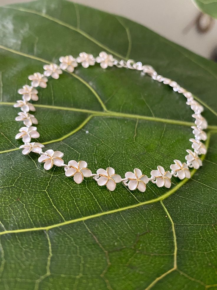 "PLUMERIA STERLING SILVER ANKLET This genuine 925 sterling silver anklet features the plumeria flower.   Makes a great gift or addition to your Hawaiian jewelry collection. Material: 925 STERLING SILVER Length available: 9\" or 9.5\" Closure:  Lobster Clasp Quantity:  1 Bracelet" Frangipani Jewellery, Hawaiian Jewelry Traditional, Plumeria Jewelry, Hawaiian Heirloom Jewelry, Dope Jewelry Accessories, Surf Jewelry, Tropical Jewelry, Hawaii Jewelry, Pretty Jewelry Necklaces