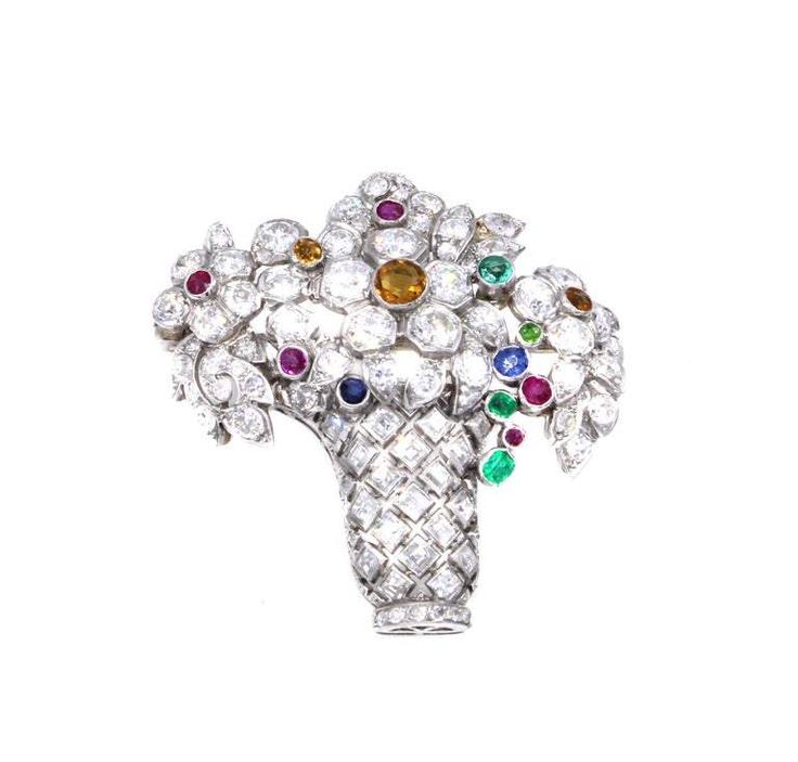 Beautifully designed and masterfully hand-crafted this Art Deco Jardinière brooch from ca 1925 is set with a mixture of bright white and sparkly Old European Cut diamonds and square step-cut diamonds. The bouquet of floral motifs are embellished with rubies, emeralds, sapphires and citrines all set at different levels and at a curve as to give a true three-dimensional appearance. A true piece of most wearable art from an interesting period in history. Width 1.62 Inch Height 1.62 Inch Weight 13.9 Gemstone Brooch, Basket Of Flowers, Flower Baskets, Diamond Brooch, Art Deco Diamond, Art Deco Jewelry, Flower Basket, Jewelry Designs, Vintage Brooches