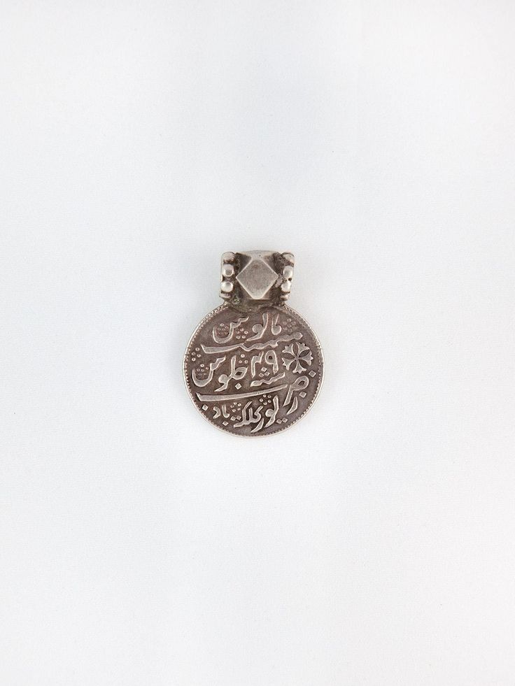 "A truly special antique Indian devotional charm worn during Islamic pilgrimages.  measurements: 1\" circumference  material: 800 silver  circa: 1920s" Traditional Medallion Necklace With Vintage Charm, Vintage Medallion Jewelry For Rituals, Traditional Necklaces With Vintage Charm And Round Pendant, Engraved Coin-shaped Amulet Jewelry, Traditional Pendant Jewelry With Vintage Charm, Traditional Vintage Charm Pendant Jewelry, Traditional Ceremonial Jewelry With Vintage Charm, Spiritual Coin Locket Jewelry, Vintage Ceremonial Jewelry With Coin Pendant