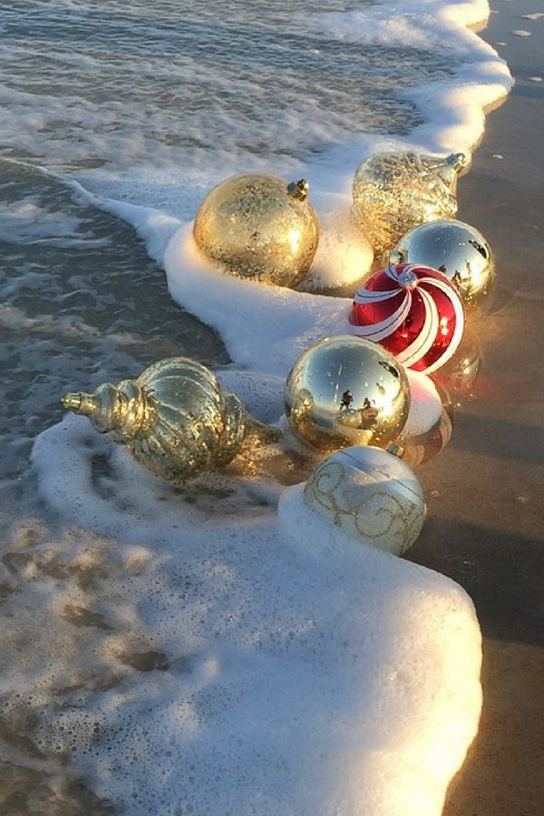 christmas ornaments lined up on the beach with text overlay that reads, ideas for the best coastal christmas ornaments