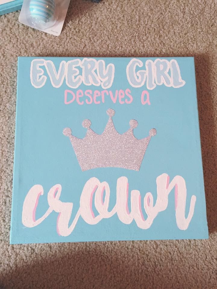 there is a blue sign that says every girl deserves a crown on the floor next to toothbrushes