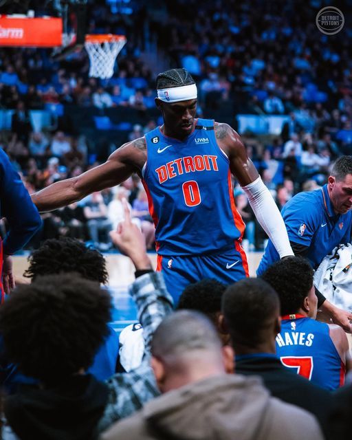 the detroit basketball team huddles around during a timeout against the denver nuggies