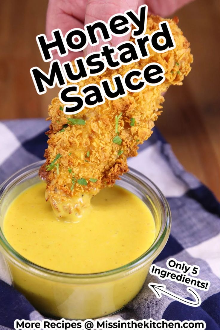 a person dipping sauce into a bowl with chicken tenders on top and the words honey mustard sauce above it