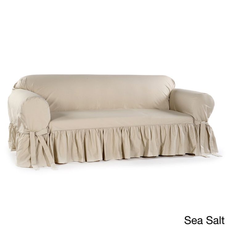 a couch with a ruffled cover on it's arm and back, sitting in front of a white background