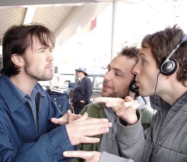 three men with headphones are talking to each other