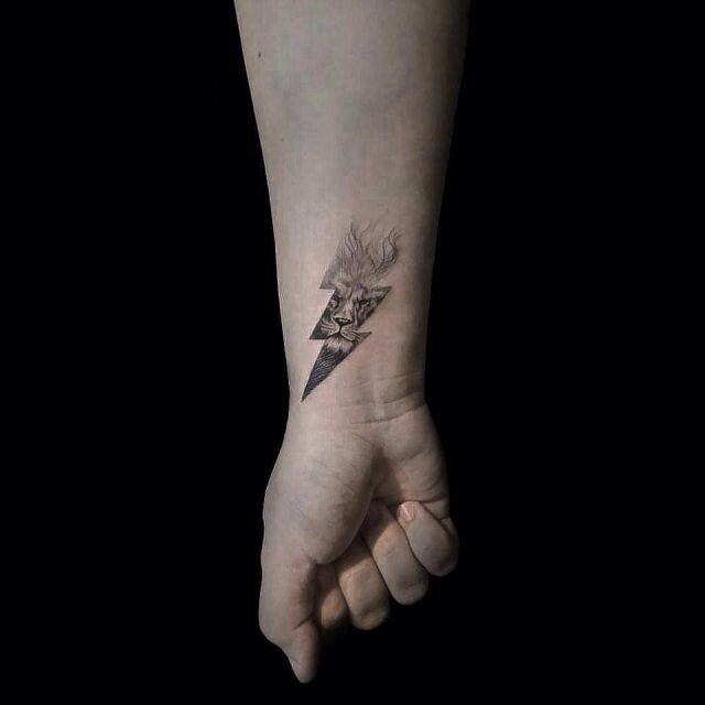 a person's hand with a tattoo on it and a lightning bolt in the middle