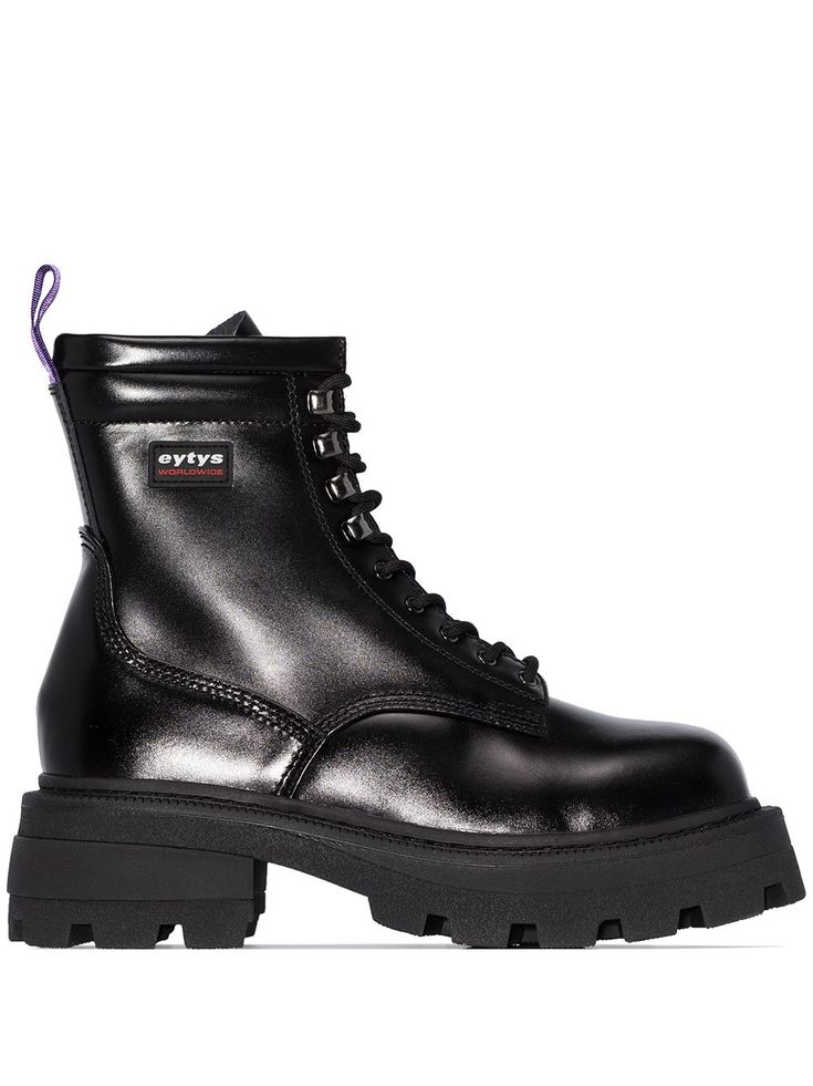 a pair of black combat boots with purple laces