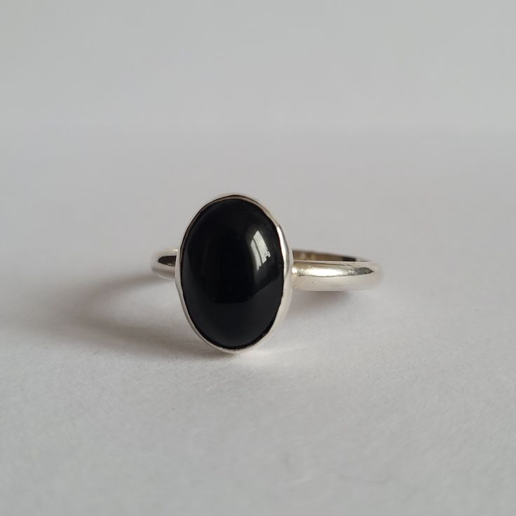 Handmade ring made from silver with black onyx stone Gemstone size: 1x1.5 cm Every piece is made by me from sterling silver (Ag 925) Classic Onyx Rings For Promise, Minimalist Onyx Rings For Formal Occasions, Minimalist Onyx Ring For Formal Occasions, Classic Onyx Promise Ring, Minimalist Sterling Silver Signet Ring With Gemstone, Minimalist Open Ring With Black Enamel, Minimalist Polished Moonstone Ring, Elegant Obsidian Ring Jewelry, Elegant Oval Sterling Silver Midi Rings