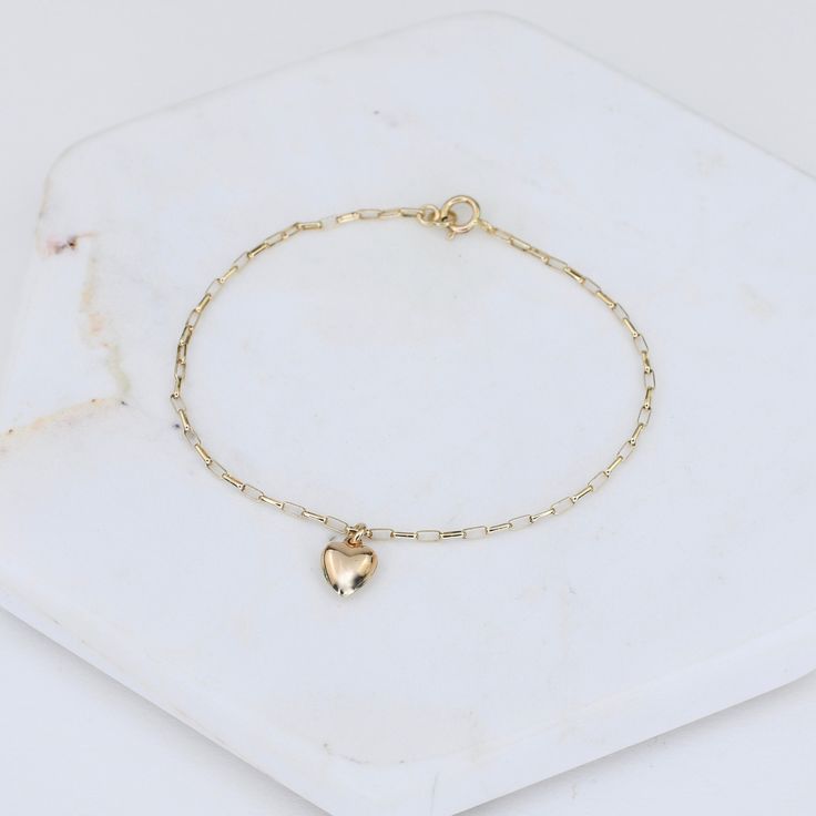 "14k Gold Heart Bracelet - Dainty 14K Gold Bracelet ★ The chain is 14k solid gold ★ The components are 14K yellow gold ★ The small heart charm is about 11 mm x 6mm, it is hollow 14k gold. The length includes the chain and the closure. ** How to choose a correct size of bracelet. 1. Measure your wrist below the wrist bone using a flexible tape measures, a string or a strip of paper. 2. If using a string or a strip of paper, mark length. Then, measure it with a ruler. 3. To find the bracelet size, 14k Gold Bracelet With Heart Charm For Everyday, 14k Gold Delicate Heart Charm Jewelry, 14k Gold Jewelry With Heart Charm For Everyday, 14k Yellow Gold Charm Bracelet For Everyday, Minimalist Gold Charm Bracelet With Heart, Dainty 14k Gold Jewelry With Heart Charm, Dainty Yellow Gold Charm Bracelet With Heart, Everyday 14k Yellow Gold Charm Bracelet, Dainty Chain Bracelet With Heart Charm For Casual Wear