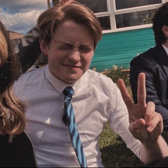 two women and a man making the peace sign with their hands in front of them