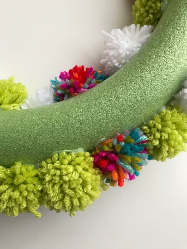 a close up of a green banana with pom - poms on it's side