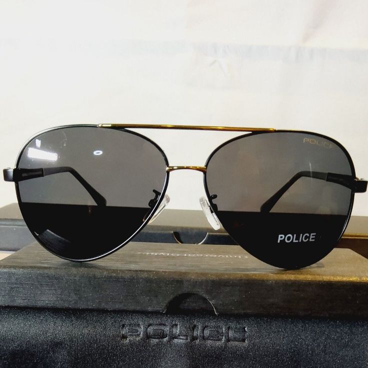 Elevate Your Style With These Fashionable Police Unisex Aviator Sunglasses. The Sleek Black/Gold Metal Frame With A 63mm Polarized Black Lens Is Perfect For Any Occasion. These Sunglasses Offer 100% Uv Protection To Shield Your Eyes From Harmful Rays. The Lightweight Design And Comfortable 135mm Temple Length Make Them Perfect For All-Day Wear. The Classic American Theme Adds A Touch Of Sophistication To Your Overall Look. These Sunglasses Are New With Tags And Come With A Sturdy Case For Safeke Black Rimless Sunglasses With Metal Frame, Black Metal Frame Aviator Sunglasses, Black Aviator Sunglasses With Uva Protection, Black Metal Frame Aviator Sunglasses For Outdoor, Black Aviator Sunglasses With Metal Frame For Outdoor, Black Aviator Sunglasses With Metal Frame, Black Polycarbonate Aviator Sunglasses With Uva Protection, Black Polycarbonate Aviator Sunglasses With Uv Protection, Outdoor Black Aviator Sunglasses Metal Frame