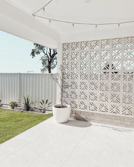 a large white planter sitting on top of a patio