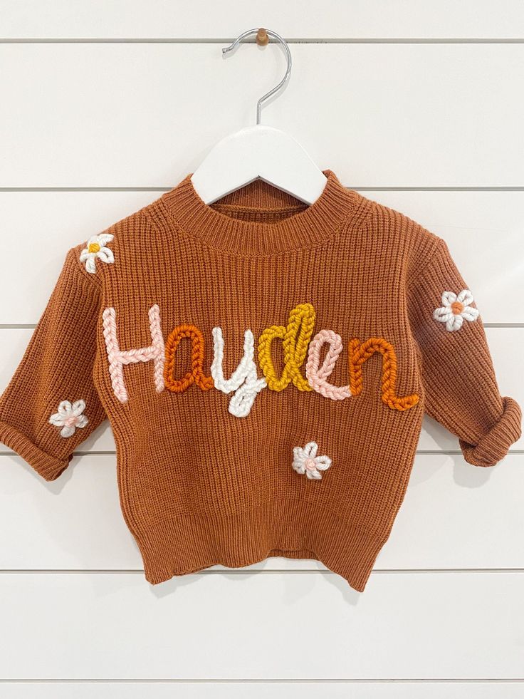 If you were looking for a custom name embroider sweater look no more! These sweaters are handmade by me with love. They are perfect for baby announcements, birthdays, or even every day! Sweaters are 100% Cotten. Each embroidery is done by hand so each sweater will vary. That's what makes them so special.  If you are looking for a color sweater that is not available please message me and I can help you find the color you are looking for!  Yarn: I can get any color yarn you would like for the name Customizable Cute Crew Neck Sweater, Cute Customizable Crew Neck Sweater, Personalized Cute Crew Neck Sweater, Cute Crew Neck Sweater With Custom Embroidery, Cute Cotton Sweater For Birthday, Handmade Cotton Crew Neck Sweater, Cute Sweater With Letter Embroidery For Fall, Cute Letter Embroidery Sweater For Fall, Embroider Sweater