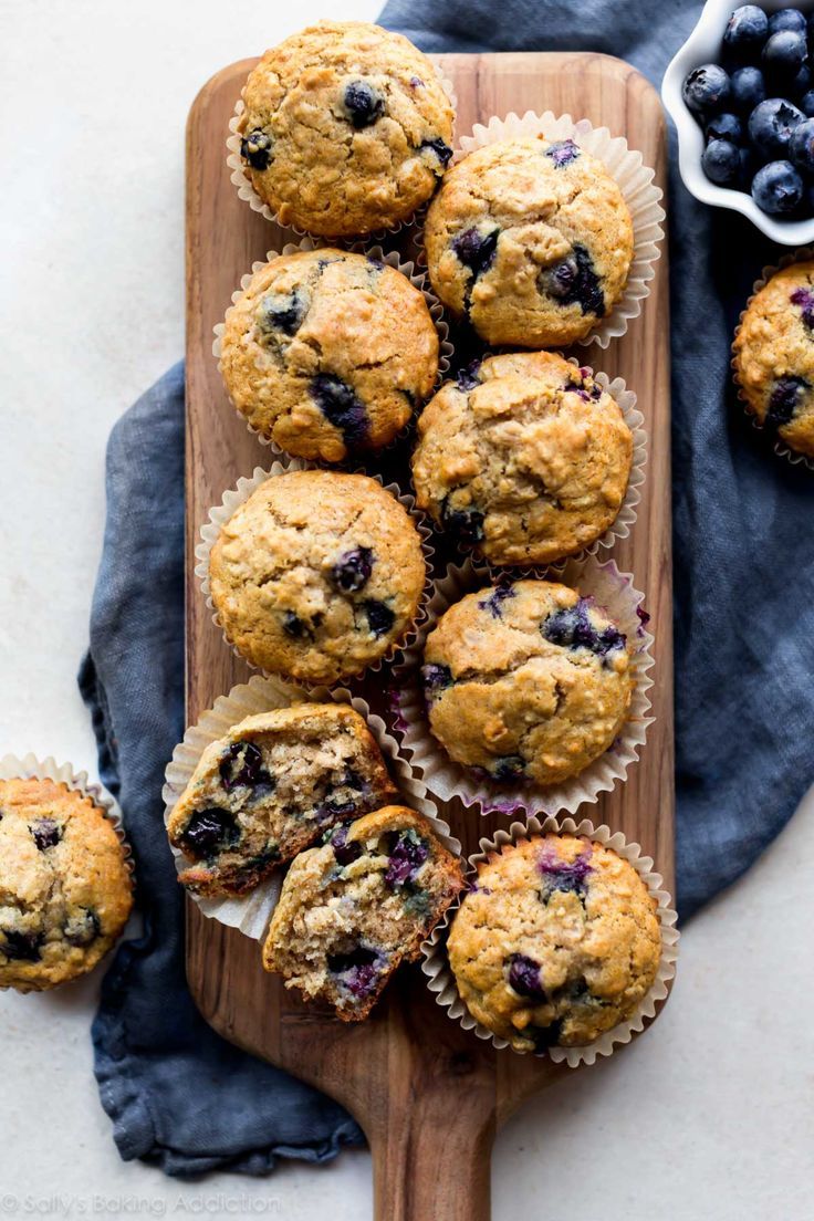 blueberry muffins on a wooden cutting board