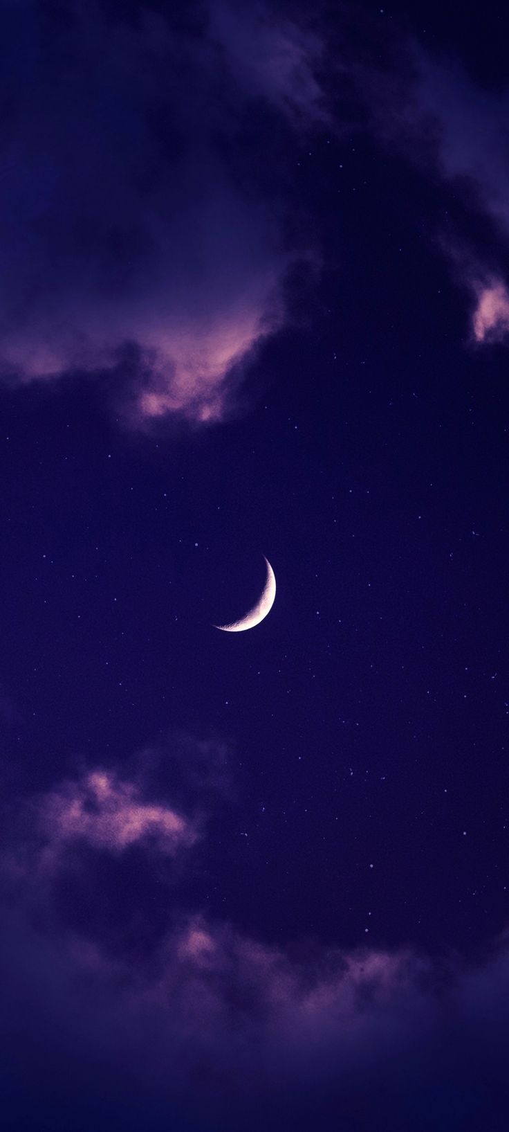 the moon is shining brightly in the night sky with clouds and stars above it, as well as some dark purple hues