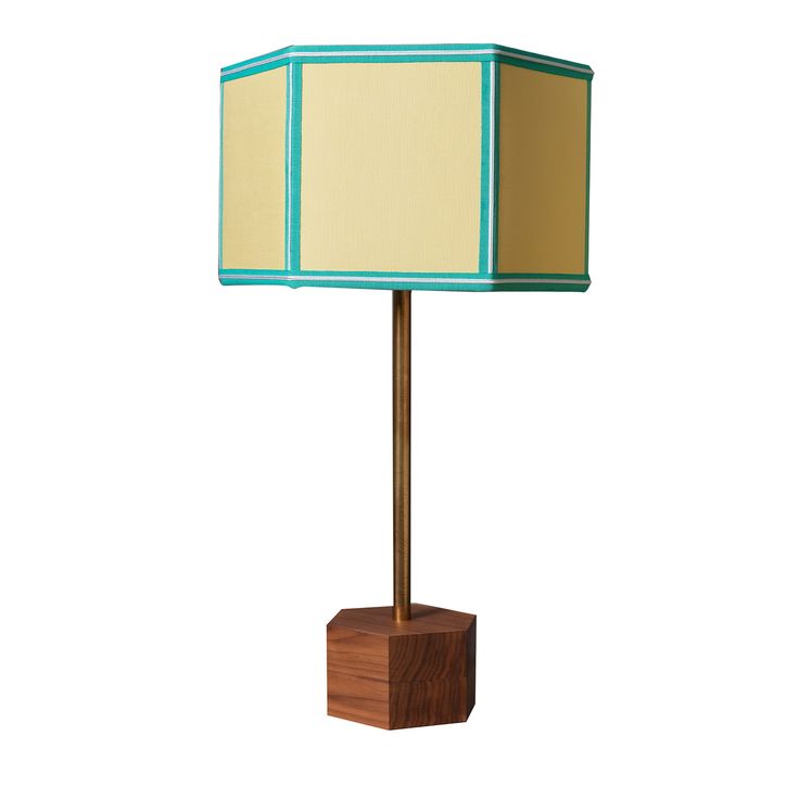 a wooden table lamp with a green and beige shade on it's base, against a white background