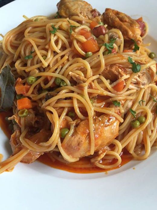 a white plate topped with pasta and meat