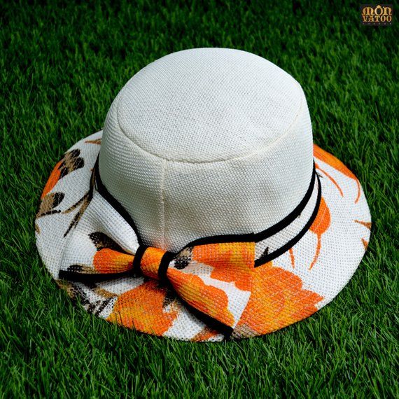 A white summer panama hat with orange flower print detail. It is a beautiful and charming hat to take everywhere with you in Summer. This beautiful orange flower print gives you the Summer bright lively vibe.Hat material: Rice strawDimension (cm): 30L x 30W x 12.5H Orange Summer Hat For Beach Season, Orange Summer Sun Hat For Vacation, White Panama Hat With Short Brim For Spring, Orange Summer Hat, White Summer Panama Hat For Kentucky Derby, Summer Beach Hats With Floral Print, Summer Floral Print Sun Hat For Vacation, Summer Sun Hat With Floral Print And Curved Brim, Vacation Floral Print Brimmed Hat