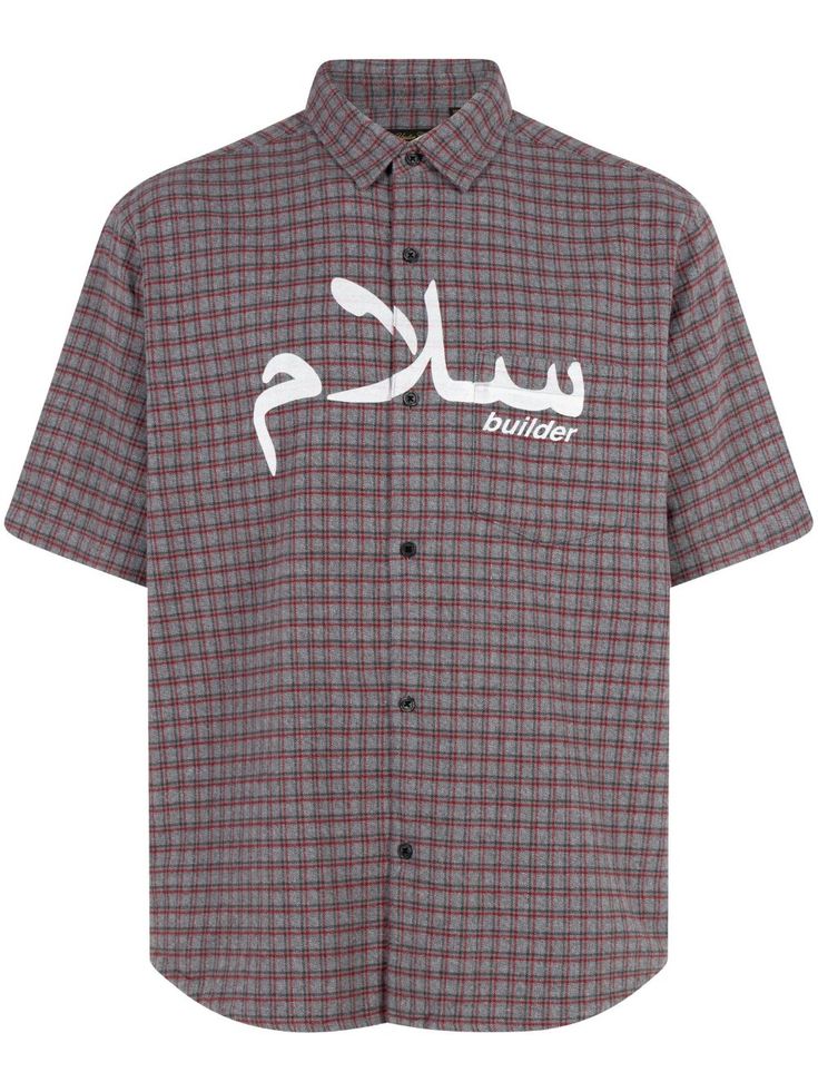 a shirt with arabic writing on the chest and white letters on the front, in black and