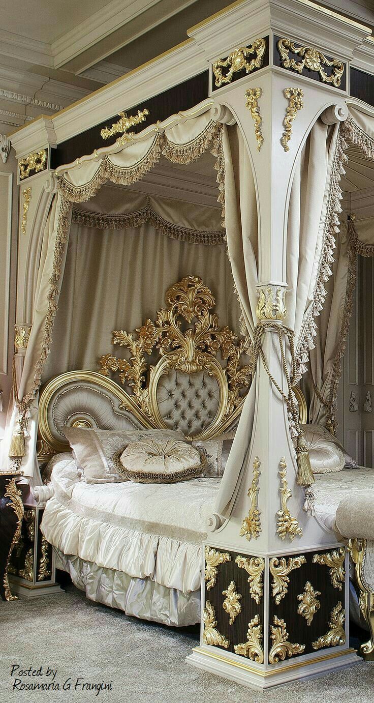 an elaborately decorated canopy bed in a bedroom