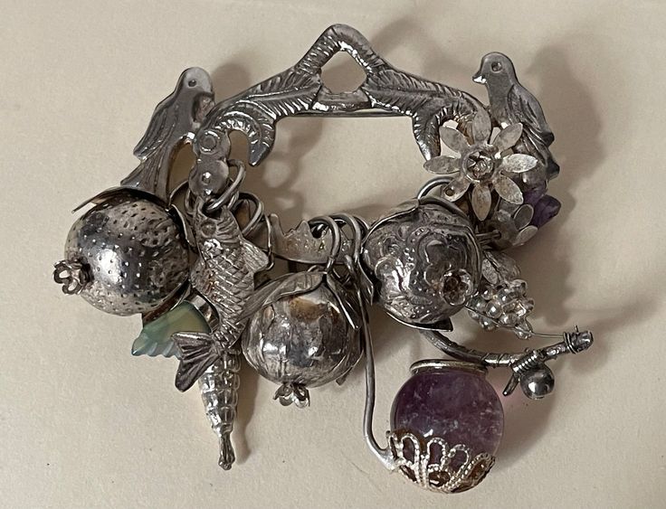 Antique  Ragastens Prata 95 Penca de Balangandan  sterling silver amulet brooch. 10 charms - amulets.  wt.: 43.22 grams  Excellent condition  marked: Prata 95 and Ragastens ( was cut, but you can see some letters ) PHOTO # 4.  all sizes approximately:  size - 2.75" x 2.75"  2 amethyst stones, 1 green stone, sterling silver ( acid tested )  Shipping with insurance, signature confirmation required. 04/26/24 SS156 Handmade Spiritual Silver Charms, Amulet Pendant Jewelry Souvenir, Souvenir Amulet Pendant Jewelry, Souvenir Pendant Amulet Jewelry, Silver Spiritual Dangle Charms, Spiritual Silver Dangle Charms, Antique Sterling Silver Charms In Silver, Antique Silver Sterling Silver Charms, Spiritual Antique Silver Jewelry With Charms